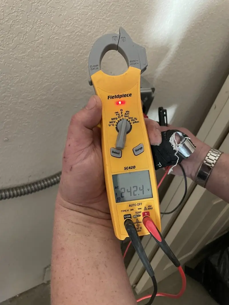 Voltage testing with clamp meter during Circuit Breaker Repair in Garden City